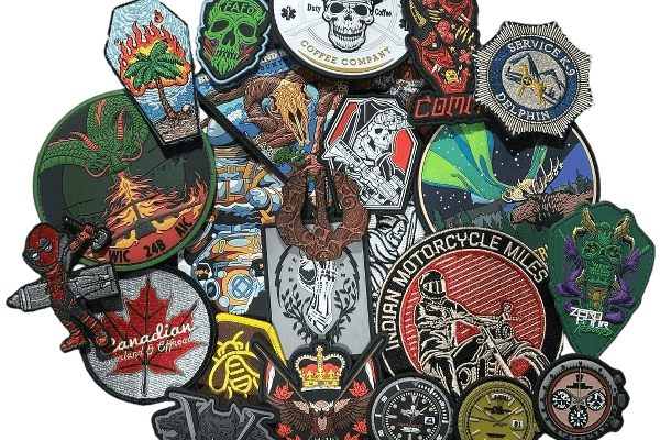 A pile of colorful custom embroidered patches — skulls, motorcycle, coffee, and brand designs